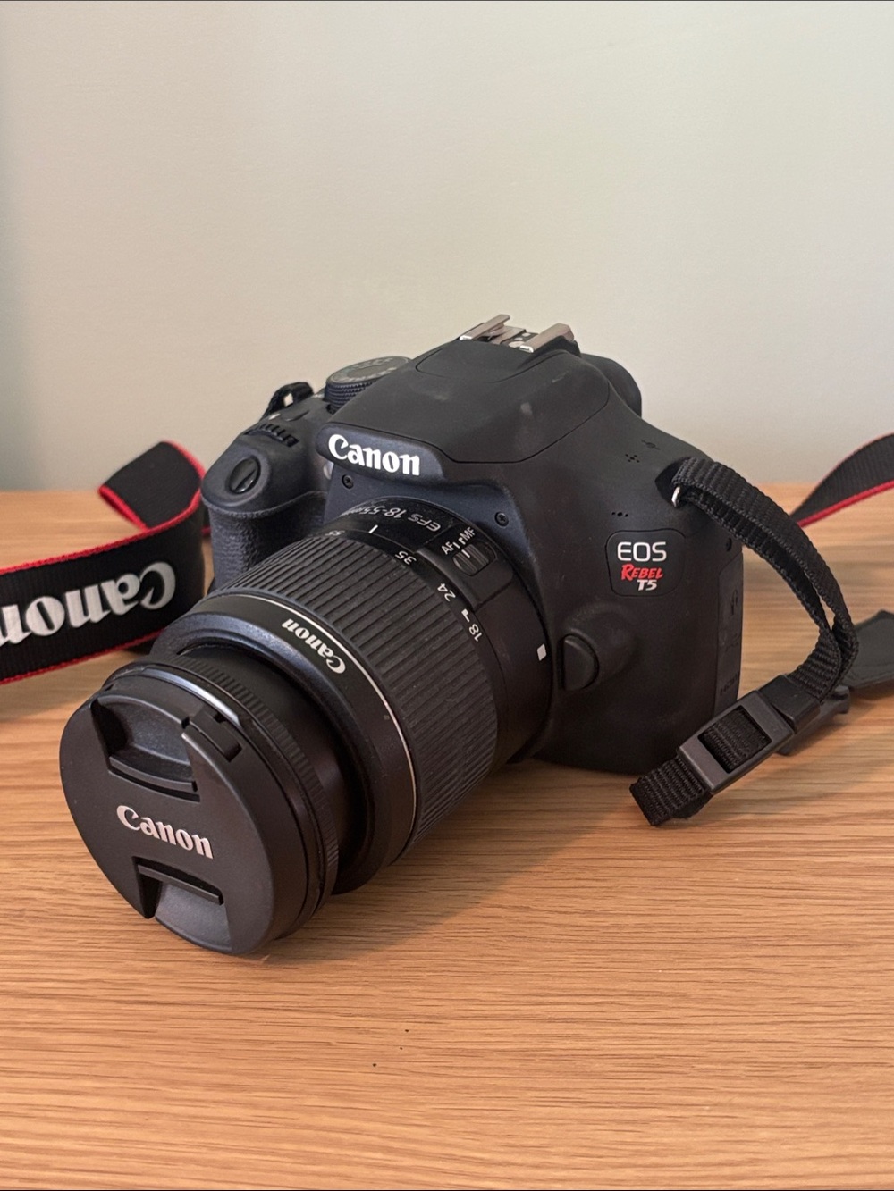 Canon EOS Rebel T5 DSLR Camera in Black with Black/Red Strap